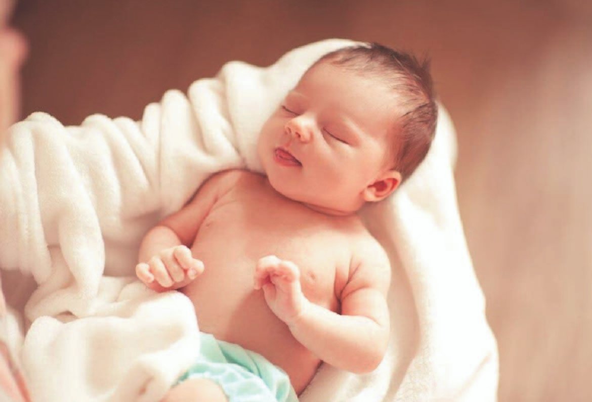 Newborn photography with parents at home, soft natural light