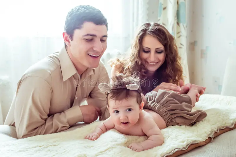 Newborn photography with soft blankets and parents' hands
